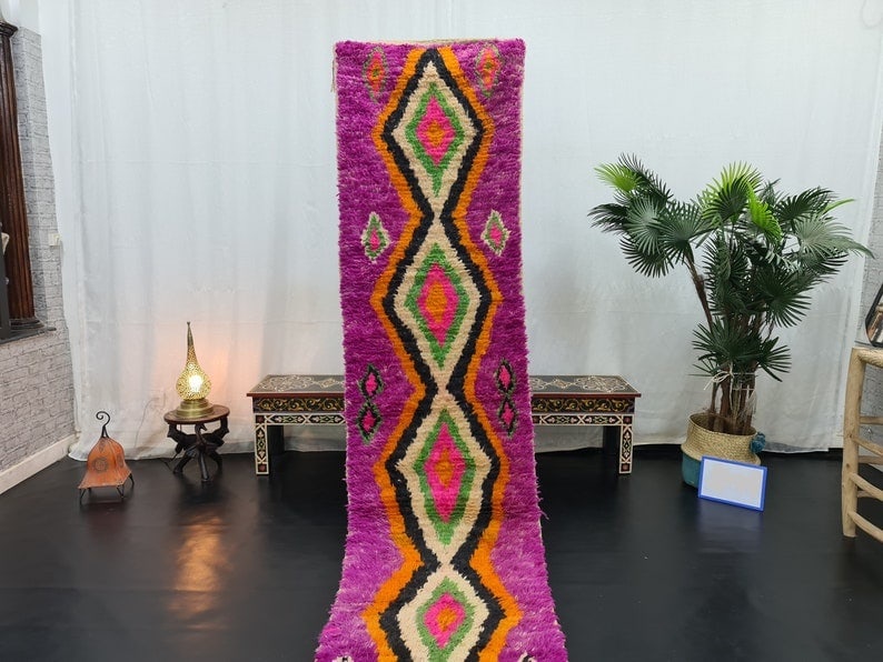 Authentic Moroccan Pink Wool Runner Rug 2 x 10 Feet: Authentic Moroccan Pink Wool Runner Rug 2 x 10 Feet Experience the charm of authentic craftsmanship with this Stunning Pink Handmade Moroccan Berber Wool Runner Rug. Handwoven by skilled Berber women 