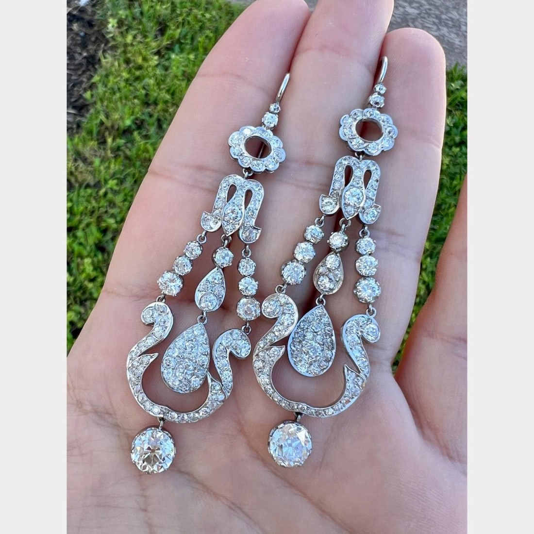 Platinum 13.50 Ct. Old Mine Diamond Chandelier Earrings: Platinum 13.50 Ct. Old Mine Diamond Chandelier Earrings These exquisite chandelier earrings are crafted in platinum and showcase a stunning total weight of 13.50 carats in diamonds. The earrings featu