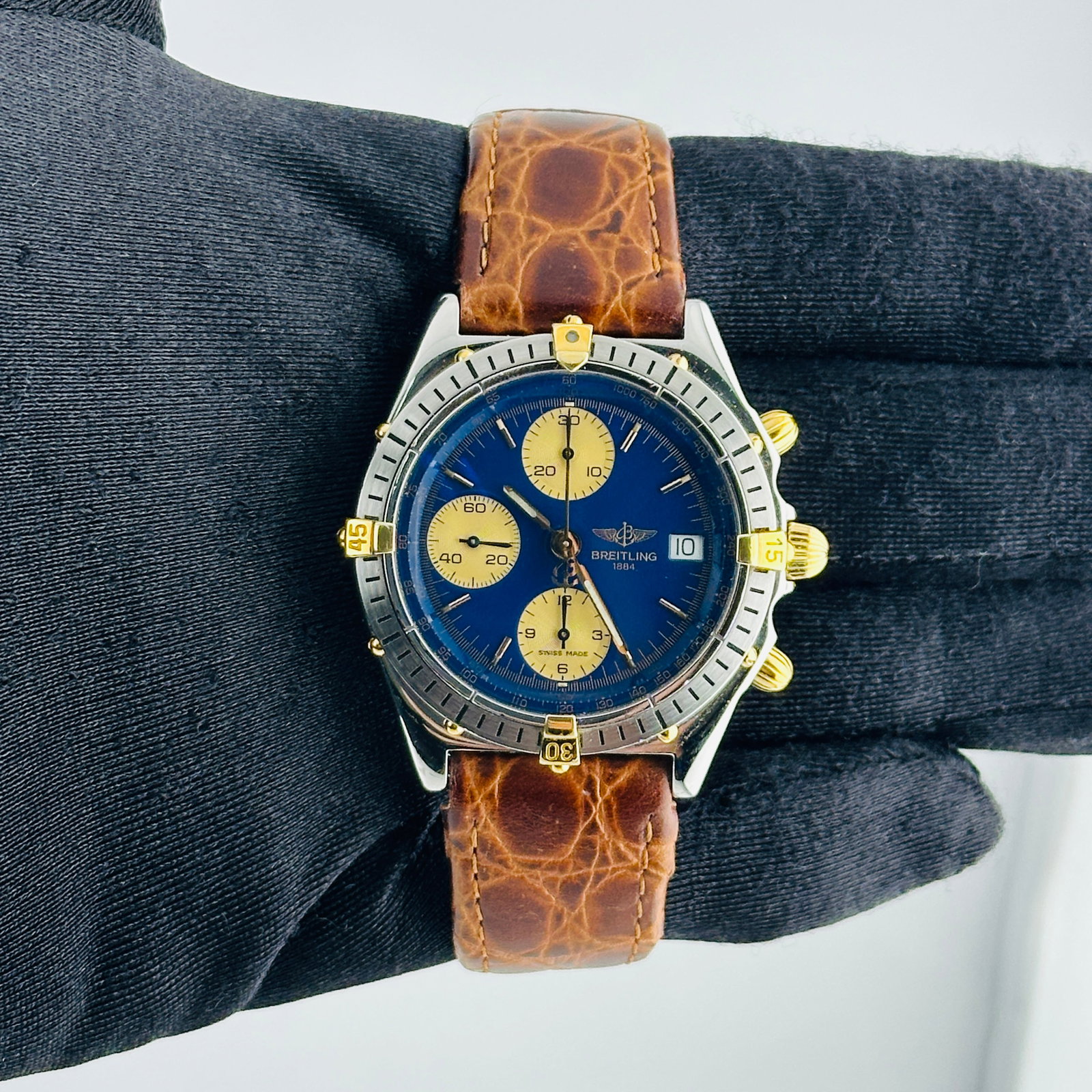 Chronomat Reference B13048 Blue Dial Watch with Aftermarket Leather Strap: Chronomat Reference B13048 Blue Dial Watch with Aftermarket Leather Strap This Breitling Chronomat watch features a blue dial and is paired with an Aftermarket leather bracelet. The timepiece is desig