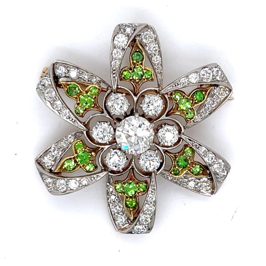 Antique 18K Platinum Diamond Garnet Brooch 54 Diamonds 24 Garnets: Antique 18K Platinum Diamond Garnet Brooch 54 Diamonds 24 Garnets This exquisite antique brooch showcases a stunning combination of 18K gold and platinum, adorned with sparkling diamonds and vibrant g