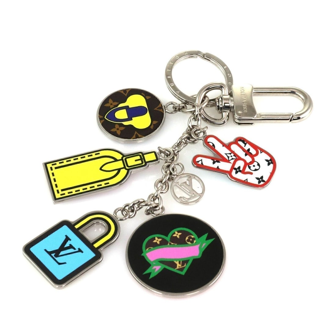 Louis Vuitton Stories bag charm key holder 5 multicolor charms: Louis Vuitton Stories bag charm key holder 5 multicolor charms This Louis Vuitton Stories bag charm and key holder features five vibrant, multicolor charms inspired by the brand's iconic motifs. Craft