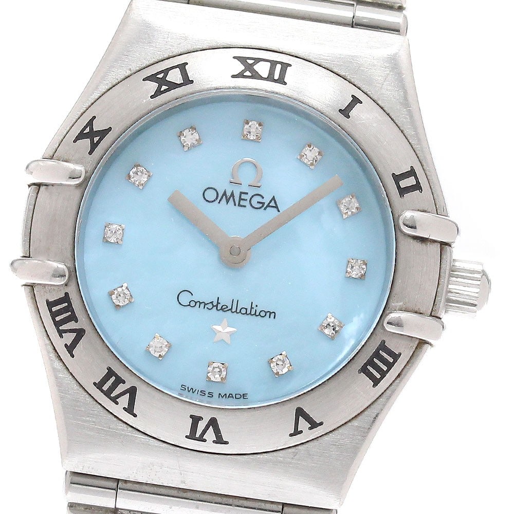 Omega Constellation Mini 1562.85 Blue Shell Quartz Watch: Omega Constellation Mini 1562.85 Blue Shell Quartz Watch This OMEGA Constellation Mini women's wristwatch features a blue shell dial adorned with 12 diamond hour markers. The watch is crafted from sta