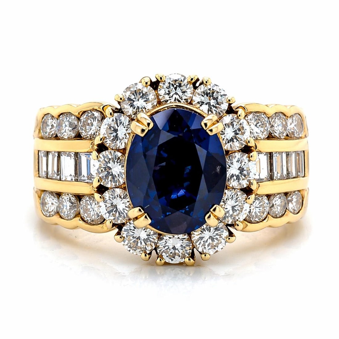 Sapphire and Diamond Ring in 18K Yellow Gold with 1.89 Carat Center Stone: Sapphire and Diamond Ring in 18K Yellow Gold with 1.89 Carat Center Stone This pre-owned ring is crafted from 18K yellow gold and features a 1.89 carat sapphire as the centerpiece. The ring is accente