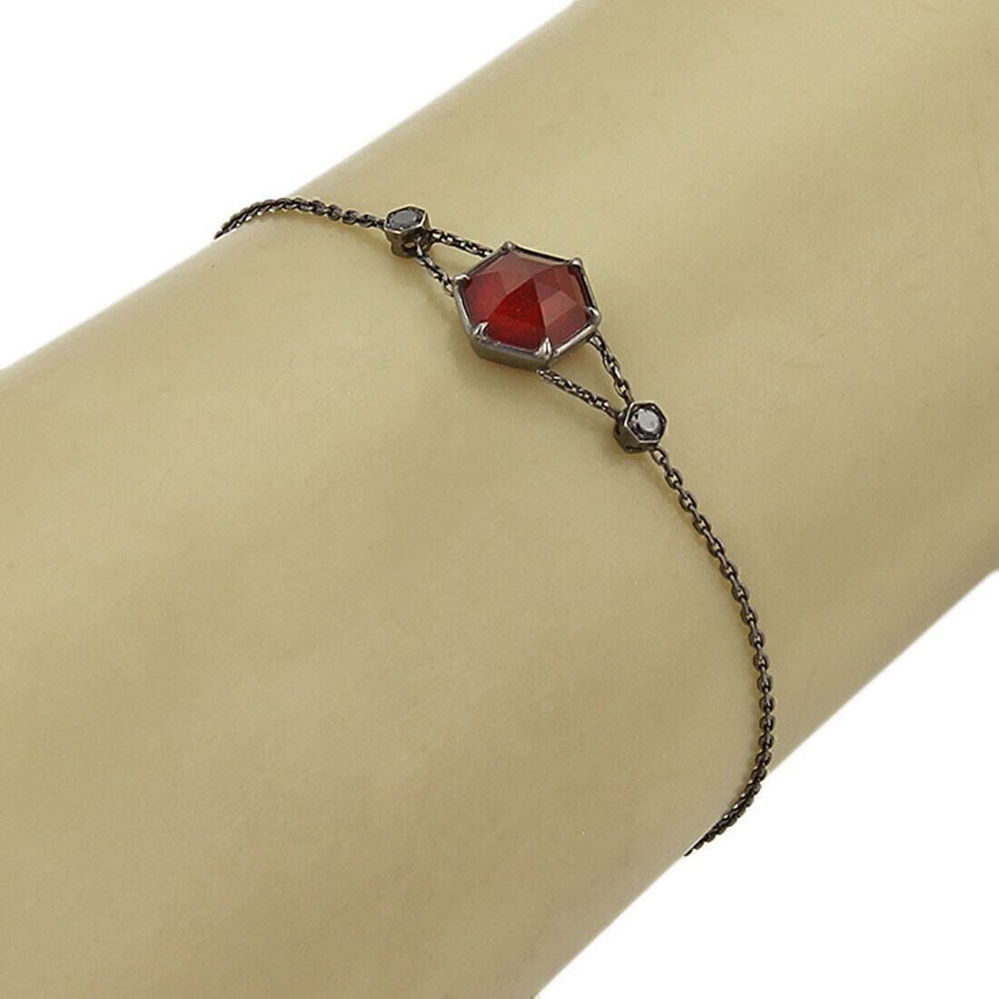 Stephen Webster Deco charm bracelet 18k black gold red quartz black diamonds: Stephen Webster Deco charm bracelet 18k black gold red quartz black diamonds This authentic Stephen Webster Deco bracelet is crafted from luxurious 18k black gold and showcases striking red quartz gem
