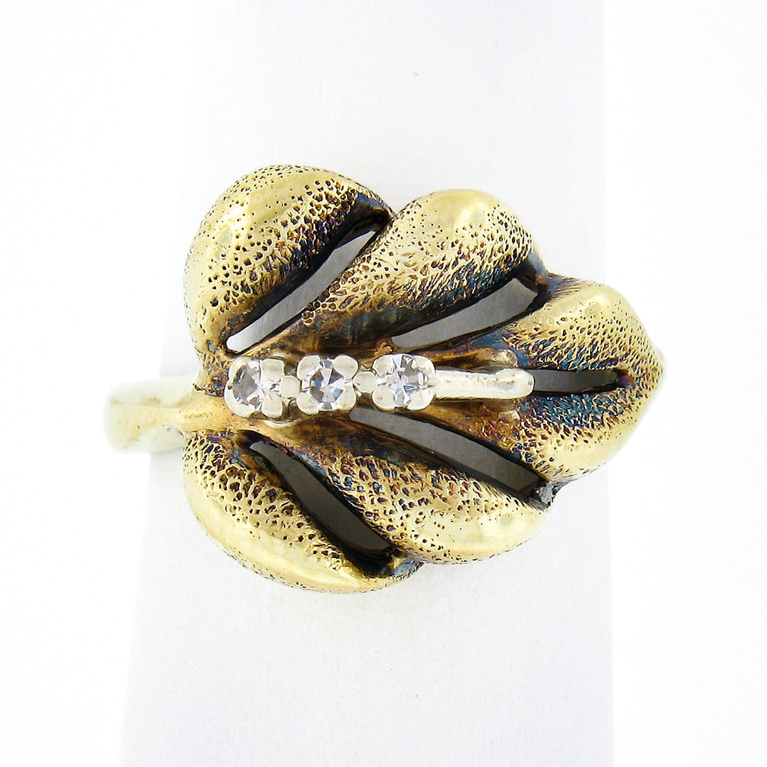 Vintage 14K Yellow Gold 3D Textured Leaf Ring with Diamonds: Vintage 14K Yellow Gold 3D Textured Leaf Ring with Diamonds This stunning vintage ring is crafted from solid 14K yellow gold, showcasing a beautiful 3D textured multi-leaf design. Centered with three 
