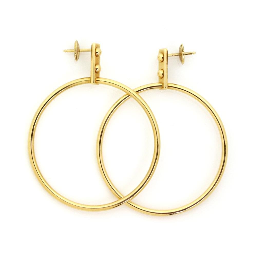 Louis Vuitton 18k Yellow Gold Large Hoop Earrings with Bead Design: Louis Vuitton 18k Yellow Gold Large Hoop Earrings with Bead Design Elevate your accessory collection with this stunning pair of authentic Louis Vuitton large fancy hoop earrings. Expertly crafted from