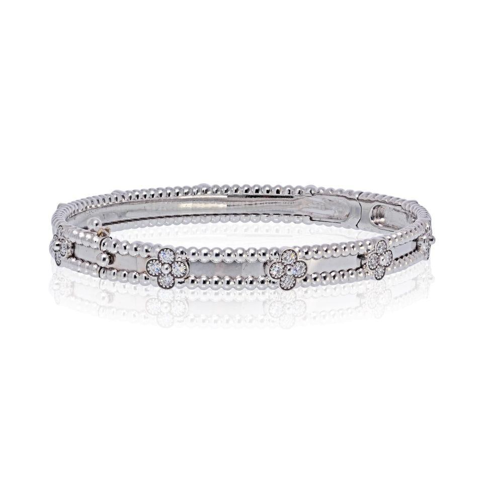 Van Cleef & Arpels 18K White Gold Perlee Clover Bracelet with Diamonds: Van Cleef & Arpels 18K White Gold Perlee Clover Bracelet with Diamonds This exquisite pre-owned Van Cleef & Arpels Perlee Clover bracelet is meticulously crafted from luxurious 18K white gold. It show
