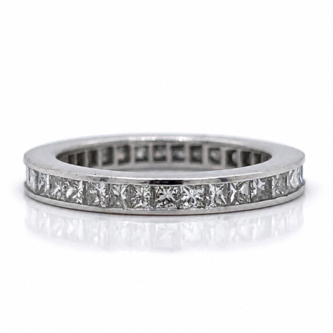 Diamond Eternity Ring 14K White Gold 1.95 Ct Princess Cut: Diamond Eternity Ring 14K White Gold 1.95 Ct Princess Cut This elegant eternity band is crafted in 14K white gold and features approximately 1.95 carats of princess-cut diamonds. The diamonds are grad