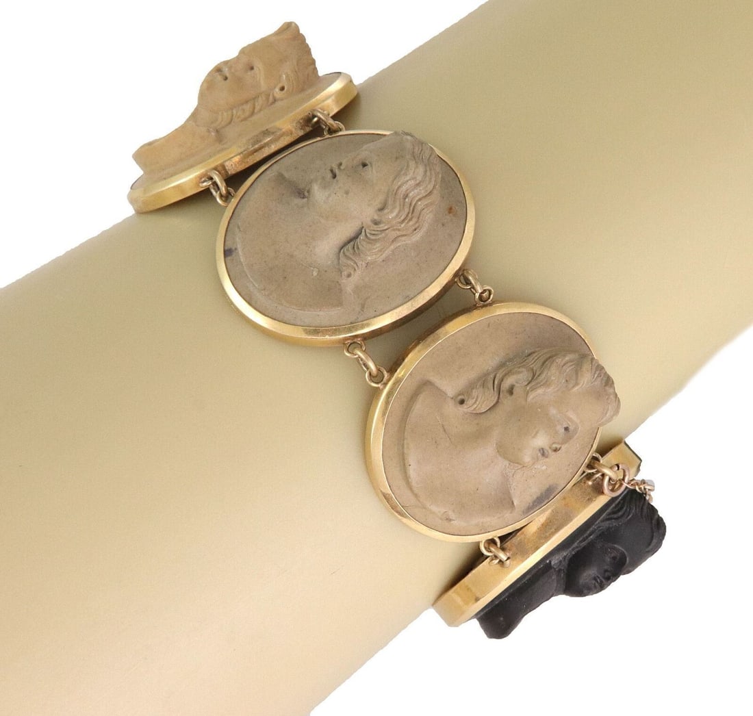 Vintage Lava Rock Cameo Link Bracelet in 18k Yellow Gold: Vintage Lava Rock Cameo Link Bracelet in 18k Yellow Gold This vintage estate bracelet features intricately carved volcanic lava rock cameos set in wide, sculptural 18k yellow gold links. The bold desi