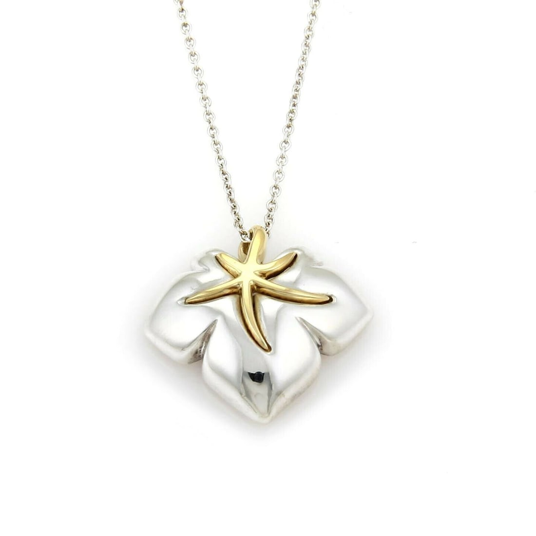 Tiffany & Co. vintage sterling silver 18k gold Ivy pendant necklace: Tiffany & Co. vintage sterling silver 18k gold Ivy pendant necklace This authentic vintage Tiffany & Co. Ivy Starfish Leaf pendant necklace features a sculptural design inspired by nature, blending st