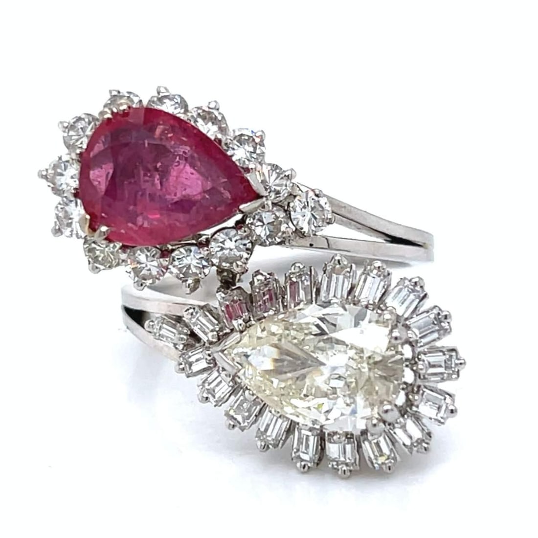 1960's Platinum Ring with 2.15 Ct Pear Diamond and Rubies: 1960's Platinum Ring with 2.15 Ct Pear Diamond and Rubies This exquisite 1960's Platinum Ruby & Diamond Ring features a stunning design that showcases a pear-shaped diamond weighing approximately 2.15