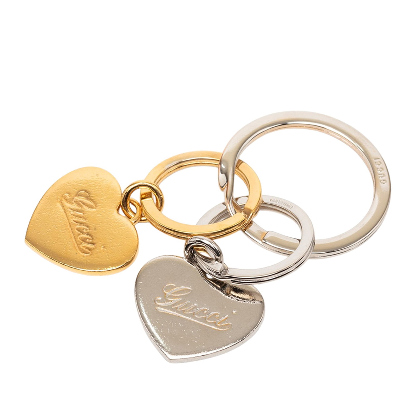 Gucci double heart gold plated brass key ring: Gucci double heart gold plated brass key ring This Gucci key ring features a stylish double heart charm in gold and silver tones, crafted from metal with gold plating and brass elements. It is equippe