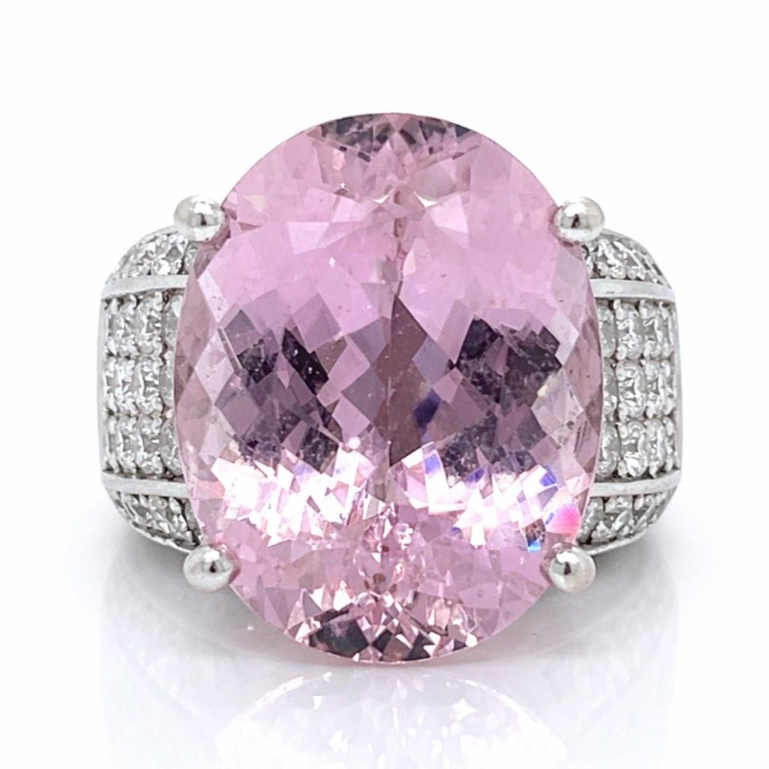Kunzite and Diamond Ring in 18K White Gold Size 5.5: Kunzite and Diamond Ring in 18K White Gold Size 5.5 This elegant ring features a large kunzite gemstone of approximately 25.00 carats, set in 18K white gold. It is accented by 66 diamonds with a total