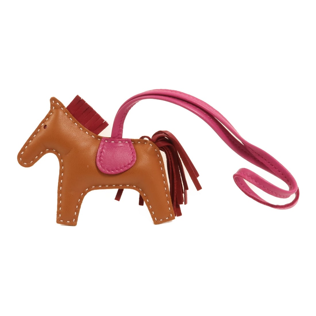 Hermes Rodeo PM Milo Lambskin Bag Charm in Brown Gold and Rubis: Hermes Rodeo PM Milo Lambskin Bag Charm in Brown Gold and Rubis This Hermes Rodeo PM Charm is crafted from Milo lambskin leather in a combination of gold, rubis, and rose pourpre colors. Designed as a