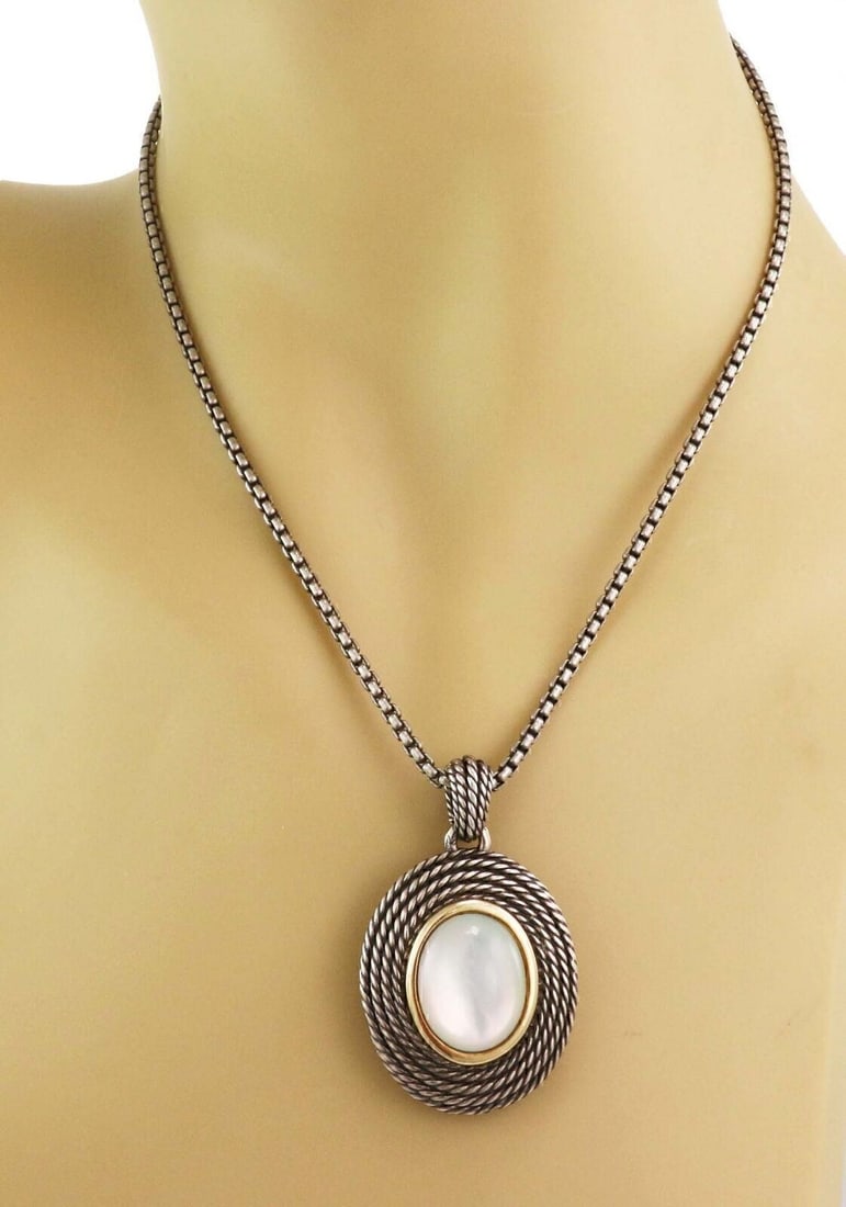 David Yurman Sterling Silver 14k Gold Mother of Pearl Pendant Necklace: David Yurman Sterling Silver 14k Gold Mother of Pearl Pendant Necklace This authentic David Yurman pendant necklace is crafted from sterling silver and 14k yellow gold, featuring a luminous oval mothe