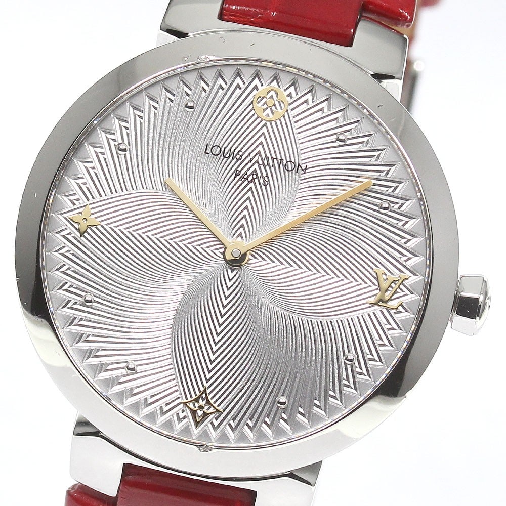 Louis Vuitton Tambour Slim Quartz 33mm Ladies Wristwatch QA015: Louis Vuitton Tambour Slim Quartz 33mm Ladies Wristwatch QA015 This Louis Vuitton Tambour Slim QA015 is a pre-owned women's wristwatch with a stainless steel case and a silver dial. It features a leat