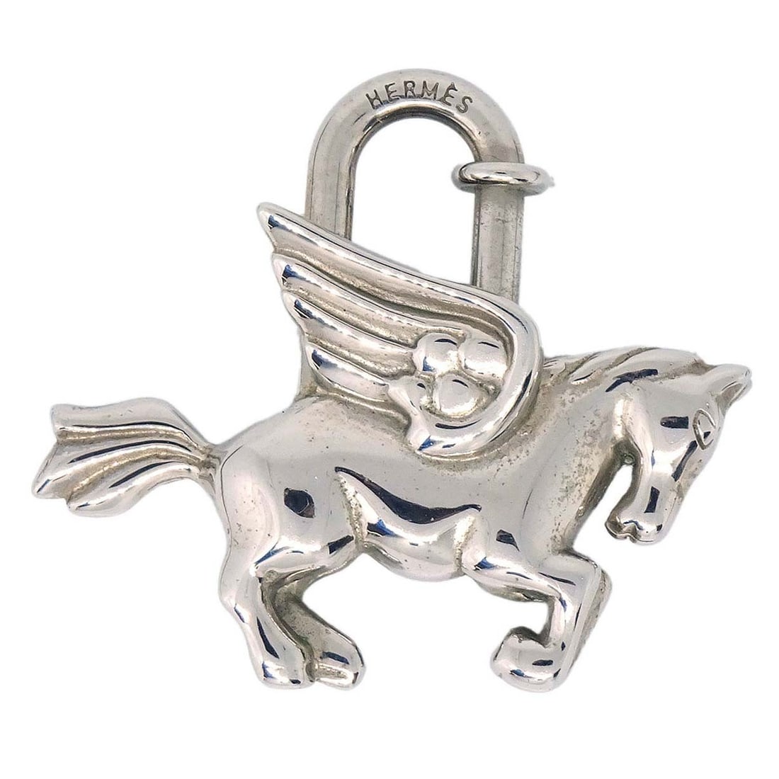 Hermes Pegasus Cadena Silver Charm 1993 Vintage: Hermes Pegasus Cadena Silver Charm 1993 Vintage This is a vintage Hermes Le Cheval Pegasus Cadena charm from 1993. Crafted in silver tone, this small charm features a classic design and is suitable fo