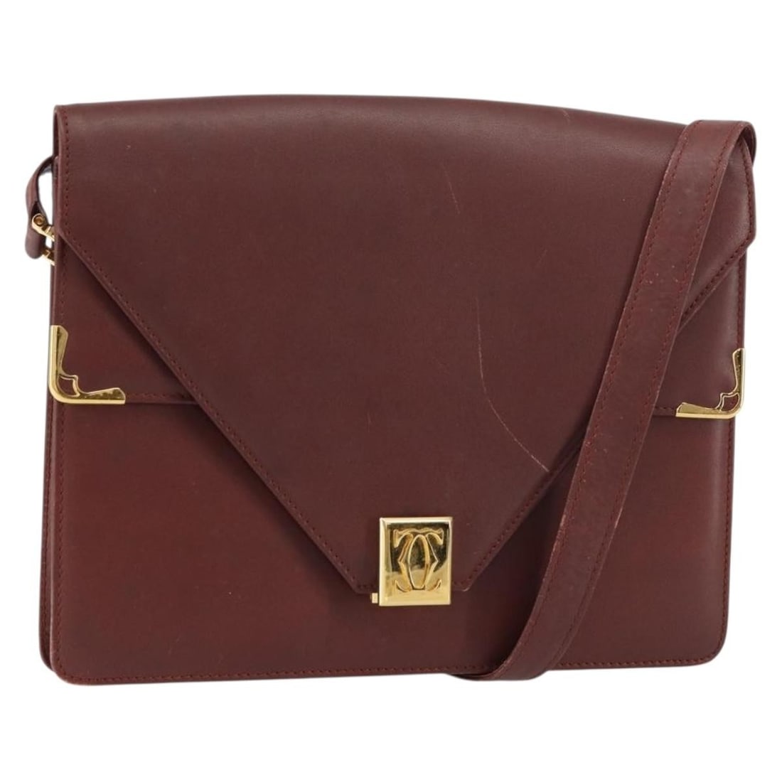 Burgundy Leather Shoulder Bag from Cartier Must Collection: Burgundy Leather Shoulder Bag from Cartier Must Collection This pre-owned Must de Cartier shoulder bag for women features burgundy leather construction with metal fittings. It exhibits signs of use in