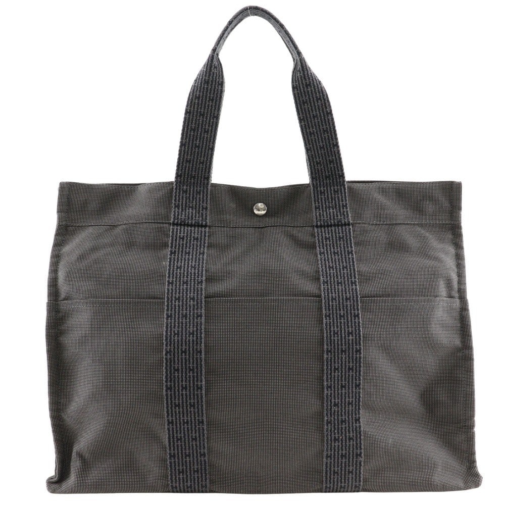 Hermes Fourre-tout Herline Gray Canvas Tote Bag 47cm by 34cm by 15cm: Hermes Fourre-tout Herline Gray Canvas Tote Bag 47cm by 34cm by 15cm The Hermes Fourre-tout Herline is a unisex tote bag crafted from durable gray canvas. It features a spacious design suitable for ev