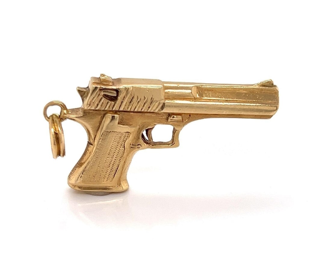 Unbranded 14k Yellow Gold Pistol Charm Pendant 20.7g: Unbranded 14k Yellow Gold Pistol Charm Pendant 20.7g This vintage charm pendant is crafted from solid 14k yellow gold and features a detailed pistol-inspired motif. The sculptural design showcases ref