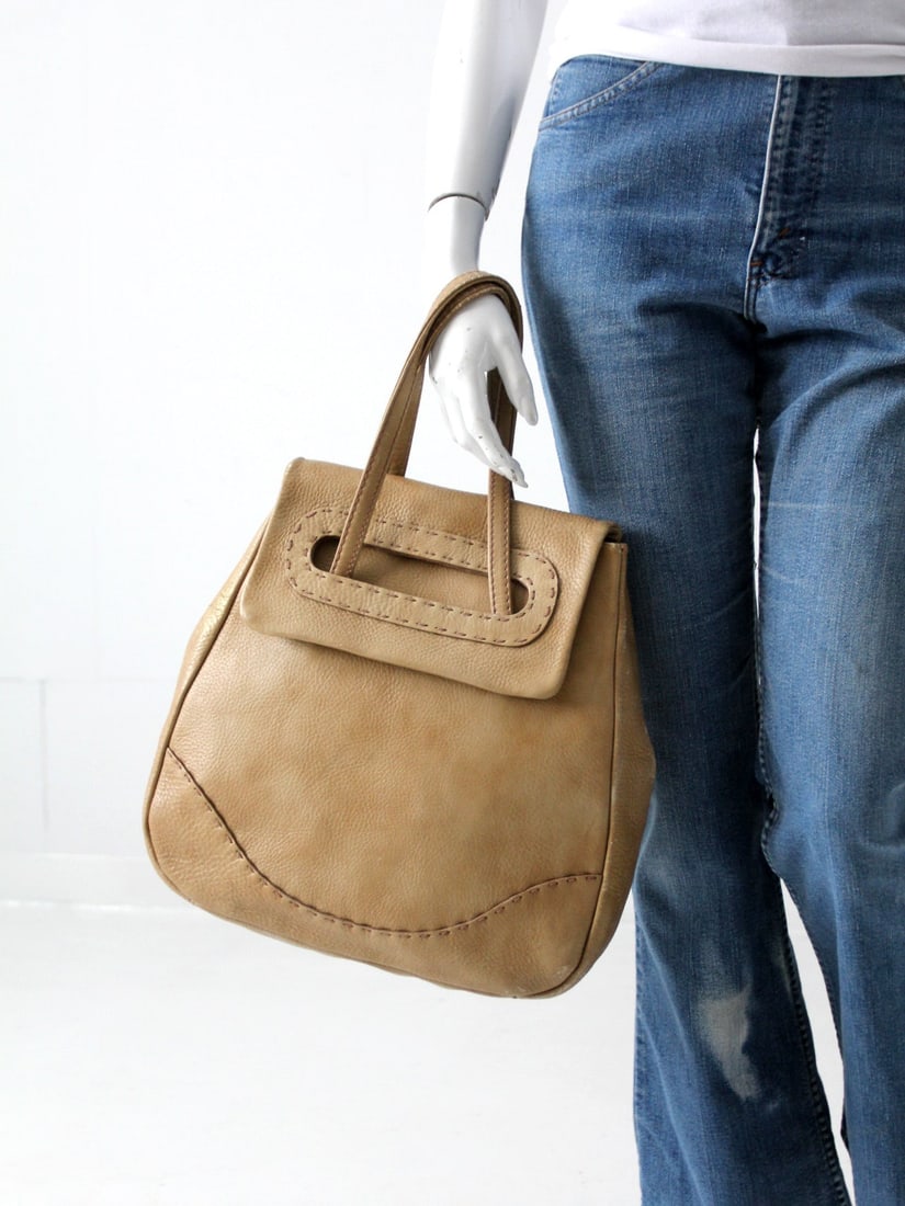 1960s Letisse Taupe Leather Purse with Brass Accents and Double Handles: 1960s Letisse Taupe Leather Purse with Brass Accents and Double Handles This 1960s Letisse handbag features smooth taupe leather with detailed topstitching and warm brass hardware, capturing a classic