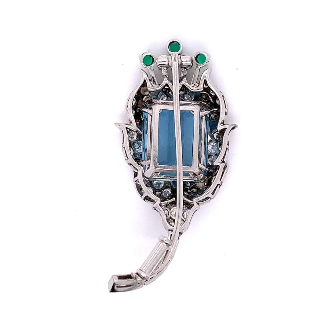 Platinum Brooch with 13 Ct Aquamarine Emeralds and Diamonds: Platinum Brooch with 13 Ct Aquamarine Emeralds and Diamonds This exquisite Platinum Aquamarine, Emerald, and Diamond Brooch showcases a stunning 13.00 Ct. to 15.00 Ct. gem-quality aquamarine at its ce