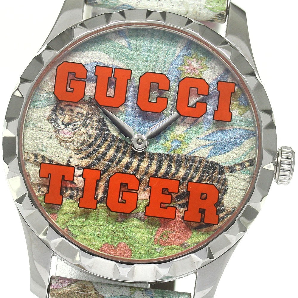 Gucci G Timeless Tiger Quartz Wristwatch 38mm Leather Band: Gucci G Timeless Tiger Quartz Wristwatch 38mm Leather Band This pre-owned Gucci G-Timeless Tiger Quartz wristwatch features a stainless steel case and a leather band. Designed for unisex wear, it show