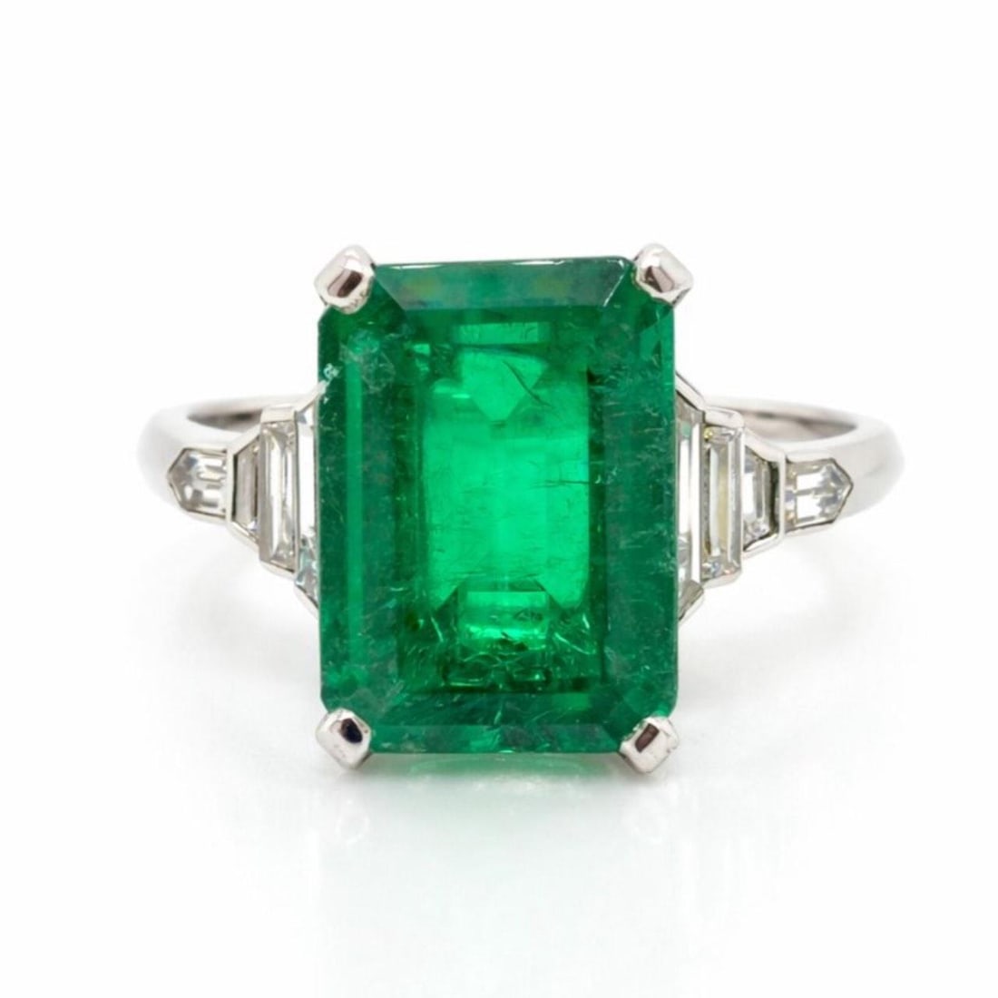 6.25 Carat Colombian Emerald and Diamond Platinum Ring: 6.25 Carat Colombian Emerald and Diamond Platinum Ring This platinum ring features an approximately 6.25 carat Colombian emerald as its centerpiece, accented by eight baguette diamonds with a total we