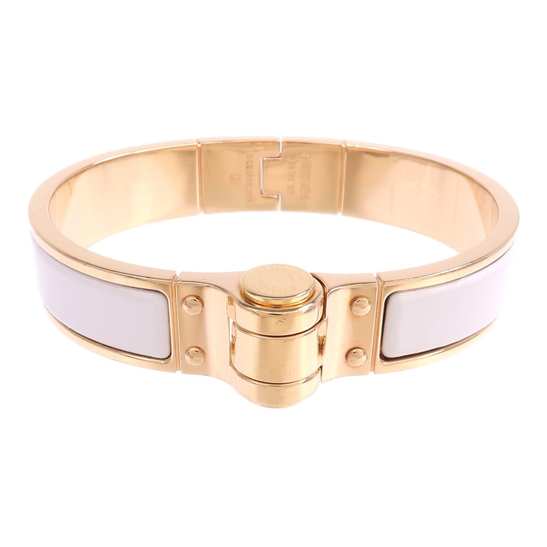 White Charniere Bangle with Gold Tone Hardware by Hermes: White Charniere Bangle with Gold Tone Hardware by Hermes This Hermes Charniere bangle features a white design with metal accents and gold tone hardware. Crafted in France, this stylish bracelet is in 