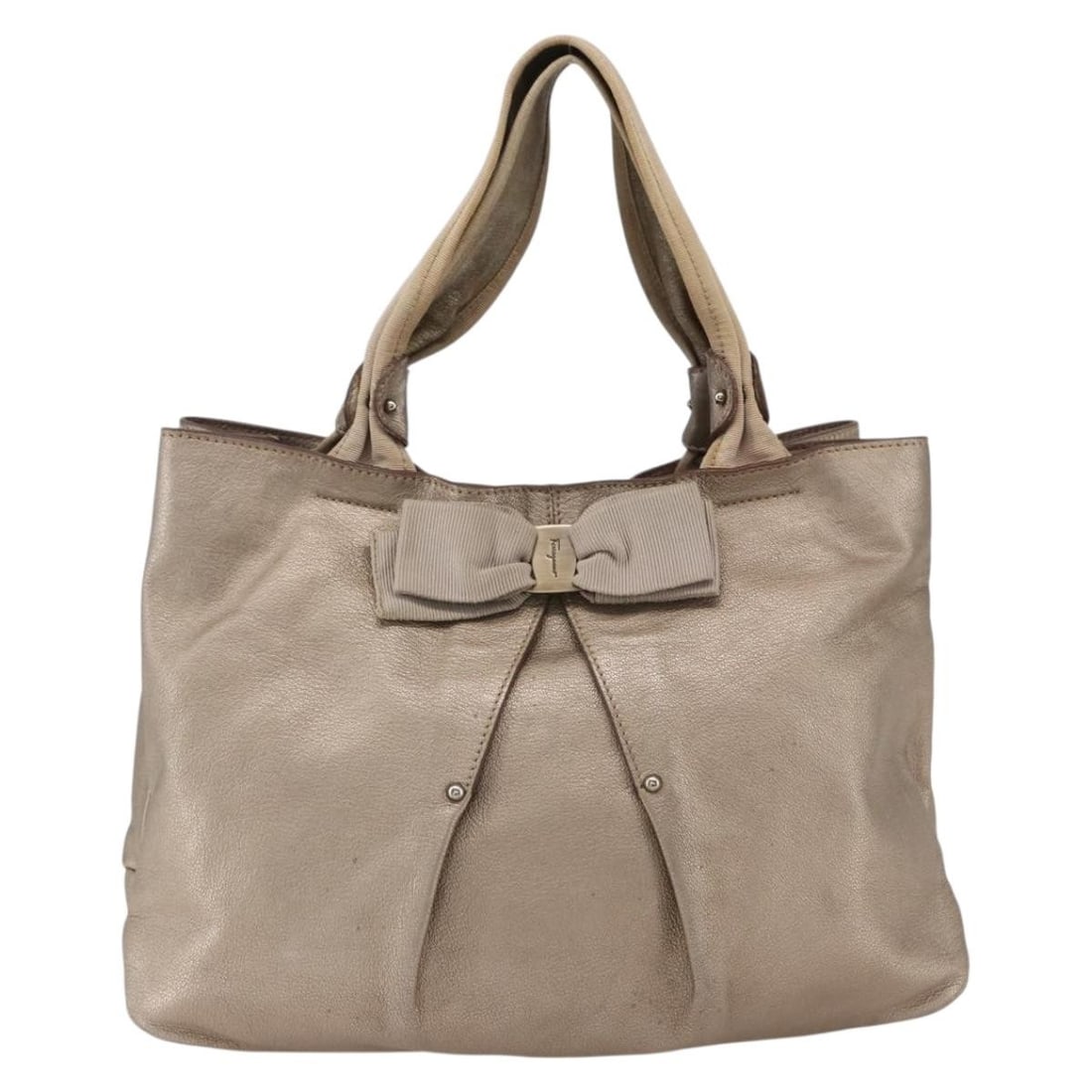 Leather Vala Satchel by Salvatore Ferragamo in Gold Tone: Leather Vala Satchel by Salvatore Ferragamo in Gold Tone This Salvatore Ferragamo Vala handbag is crafted from gold-colored leather and designed for women. It features a spacious interior and a struct
