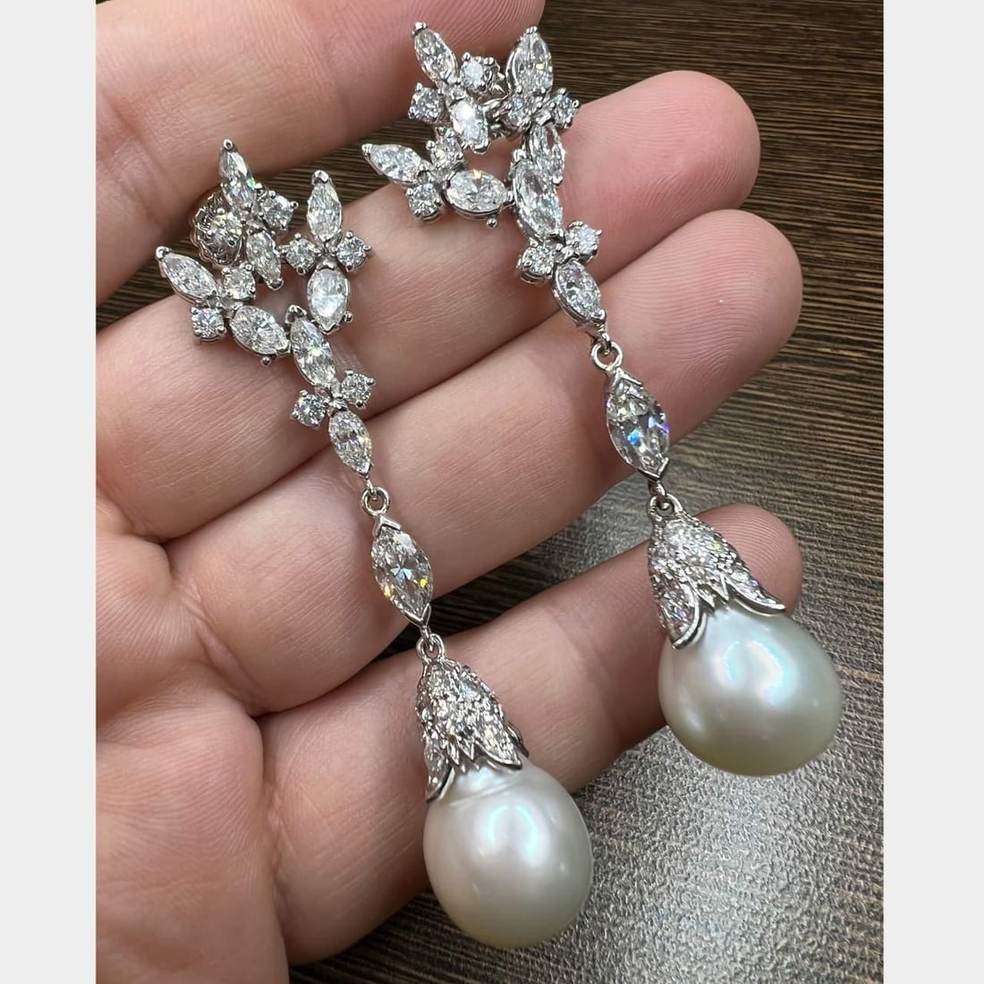 1960s 18K White Gold Platinum Diamond South Sea Pearl Earrings: 1960s 18K White Gold Platinum Diamond South Sea Pearl Earrings Discover a stunning pair of 1960's earrings crafted from 18K white gold and platinum. These exquisite earrings feature 10 marquise diamon