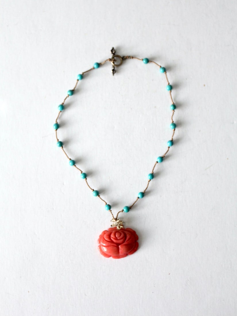 Vintage Coral Floral Pendant Necklace with Turquoise Beads: Vintage Coral Floral Pendant Necklace with Turquoise Beads This vintage floral pendant necklace features a beautifully carved stone pendant resembling a coral-shaped flower, elegantly suspended from a