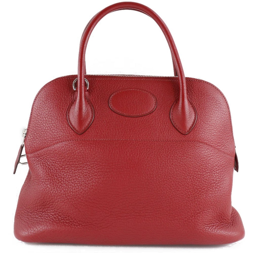 Red Clemence Leather Bolide Bag by Hermes 31cm France: Red Clemence Leather Bolide Bag by Hermes 31cm France This Hermes Bolide Bag is crafted from red leather and features a classic silhouette designed for women. Made in France, it offers a spacious inte