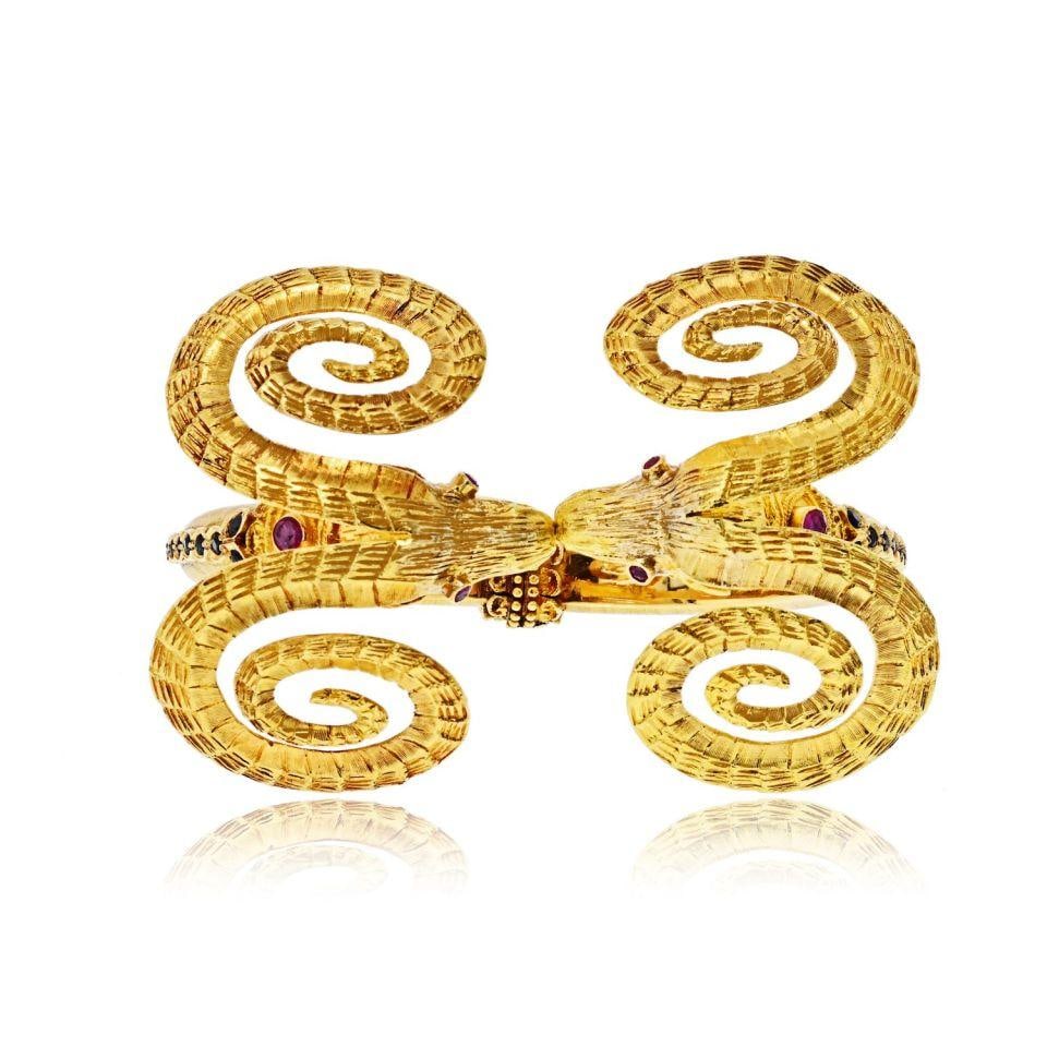 Lalaounis 18K Yellow Gold Double Ram Ruby Cuff Bracelet: Lalaounis 18K Yellow Gold Double Ram Ruby Cuff Bracelet This vintage Ilias Lalaounis bracelet is crafted from richly textured 18K yellow gold and features a striking double ram motif with oversized sp