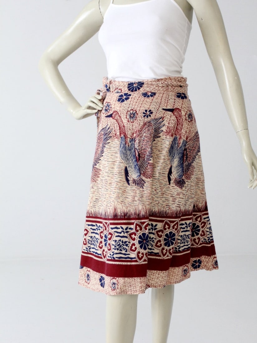 1970s Vintage Cream Wrap Skirt with Bird Print: 1970s Vintage Cream Wrap Skirt with Bird Print This vintage 1970s wrap skirt is crafted from soft India cotton, featuring an airy cream fabric adorned with a beautifully hand-crafted print of birds in