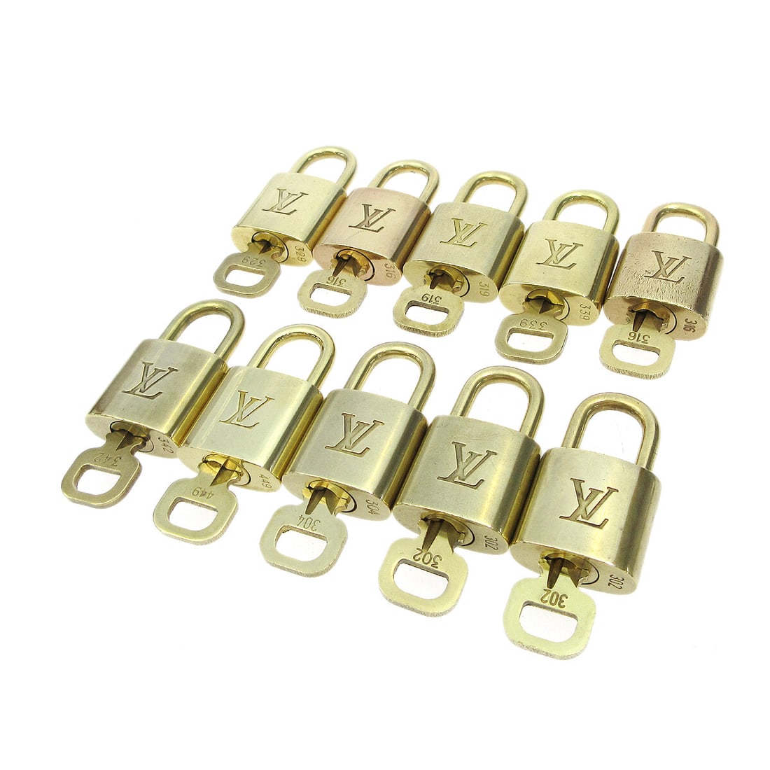 Louis Vuitton gold padlock key charm set of 10: Louis Vuitton gold padlock key charm set of 10 This is a set of ten Louis Vuitton padlock and key bag accessories in a gold tone finish. Designed for unisex use, these padlocks feature the iconic Loui