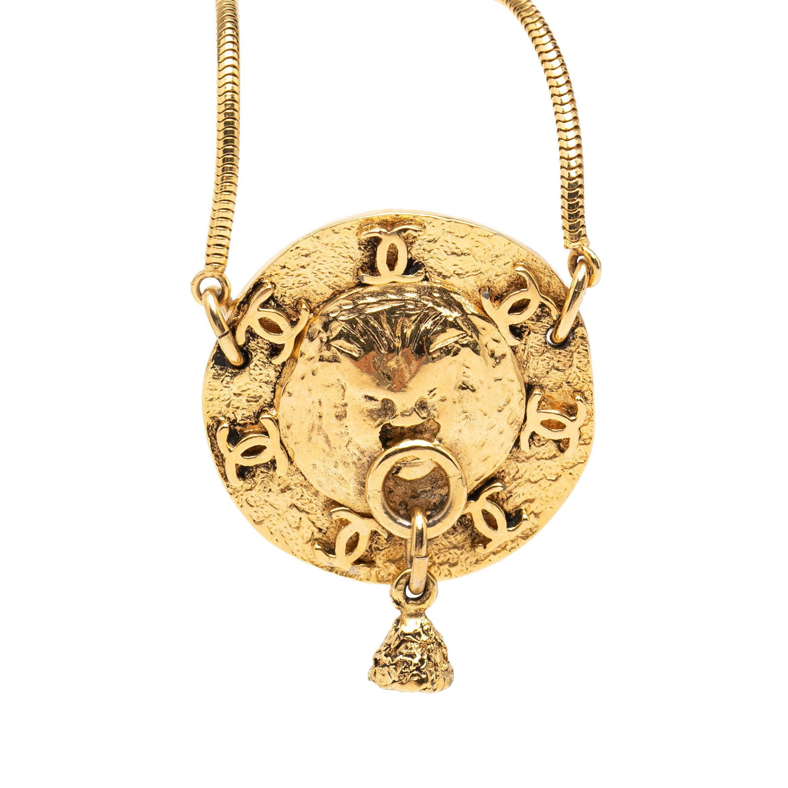 Chanel lion medallion gold tone necklace: Chanel lion medallion gold tone necklace This Chanel necklace features a gold-tone metal construction with a striking lion motif medallion pendant. It is secured with a spring ring closure and showcas