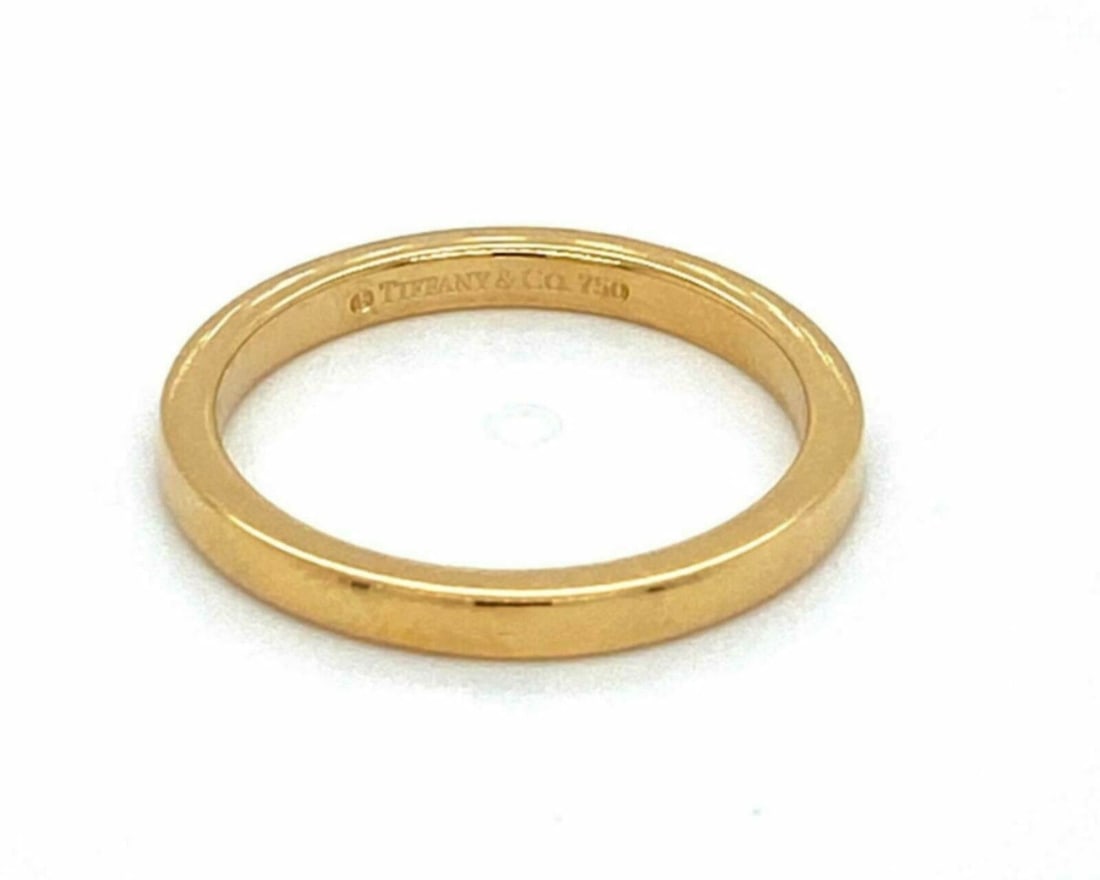 Tiffany & Co Novo 18k Yellow Gold Size 4 Band Ring: Tiffany & Co Novo 18k Yellow Gold Size 4 Band Ring This Tiffany & Co. Novo ring is crafted from solid 18k yellow gold and features a slim, polished band with a minimalist design. Measuring approximate