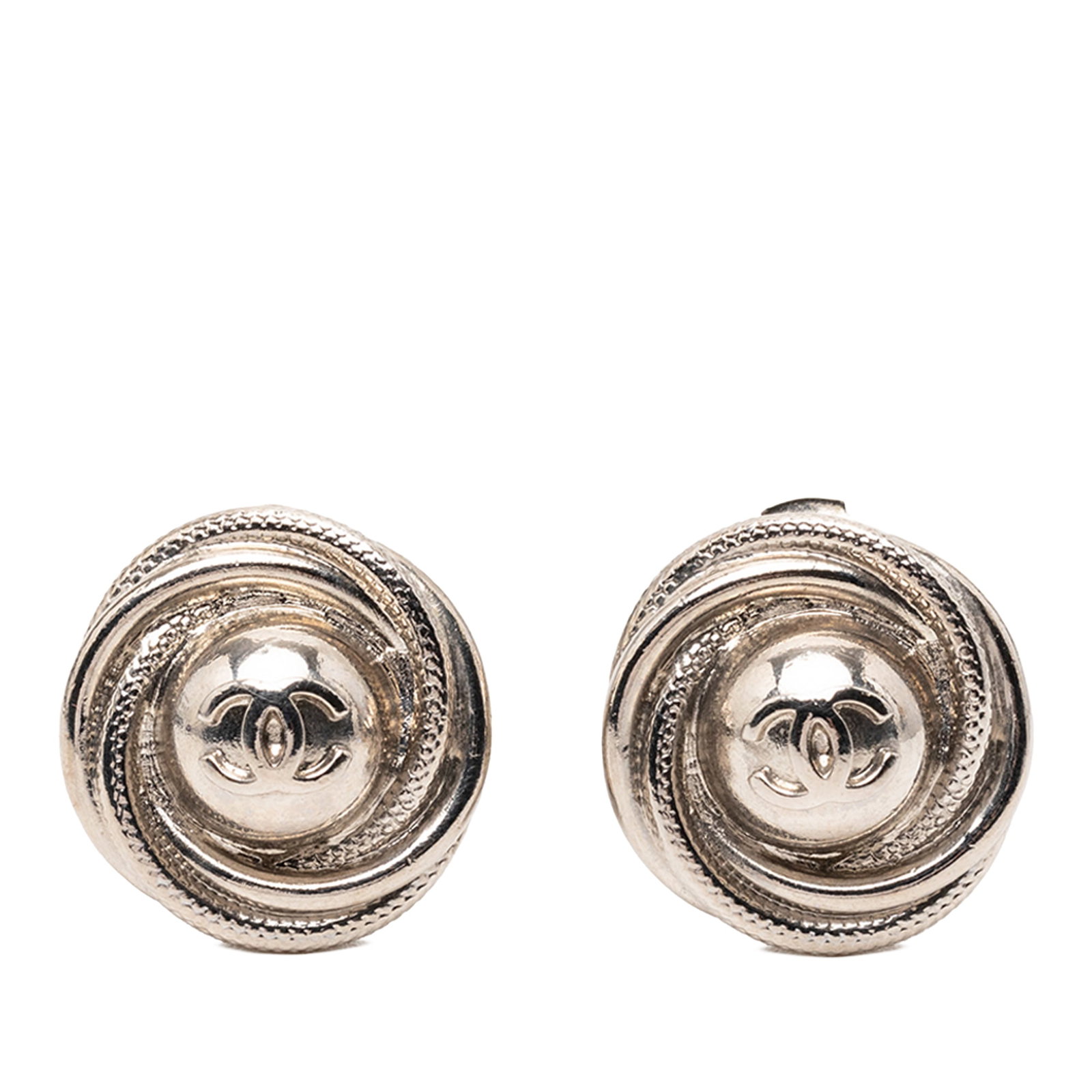 Chanel CC Silver Tone Metal Round Clip Earrings: Chanel CC Silver Tone Metal Round Clip Earrings These Chanel CC round clip-on earrings feature silver-plated metal bodies with back clip-on closures. Designed as costume jewelry, they showcase the ico