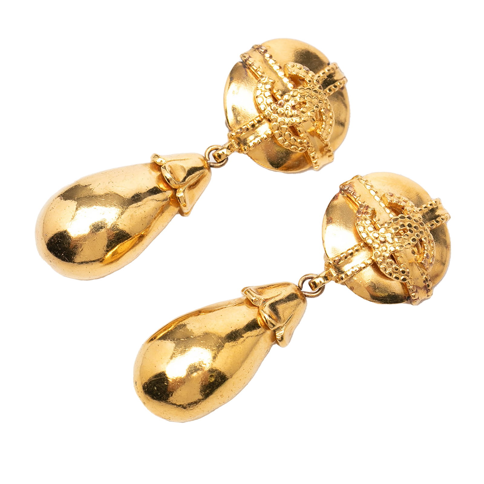 Chanel CC Gold Tone Metal Clip On Dangle Earrings: Chanel CC Gold Tone Metal Clip On Dangle Earrings These Chanel CC gold-tone dangle earrings feature a classic clip-on closure and a striking dangling design. Crafted from metal, they showcase the icon