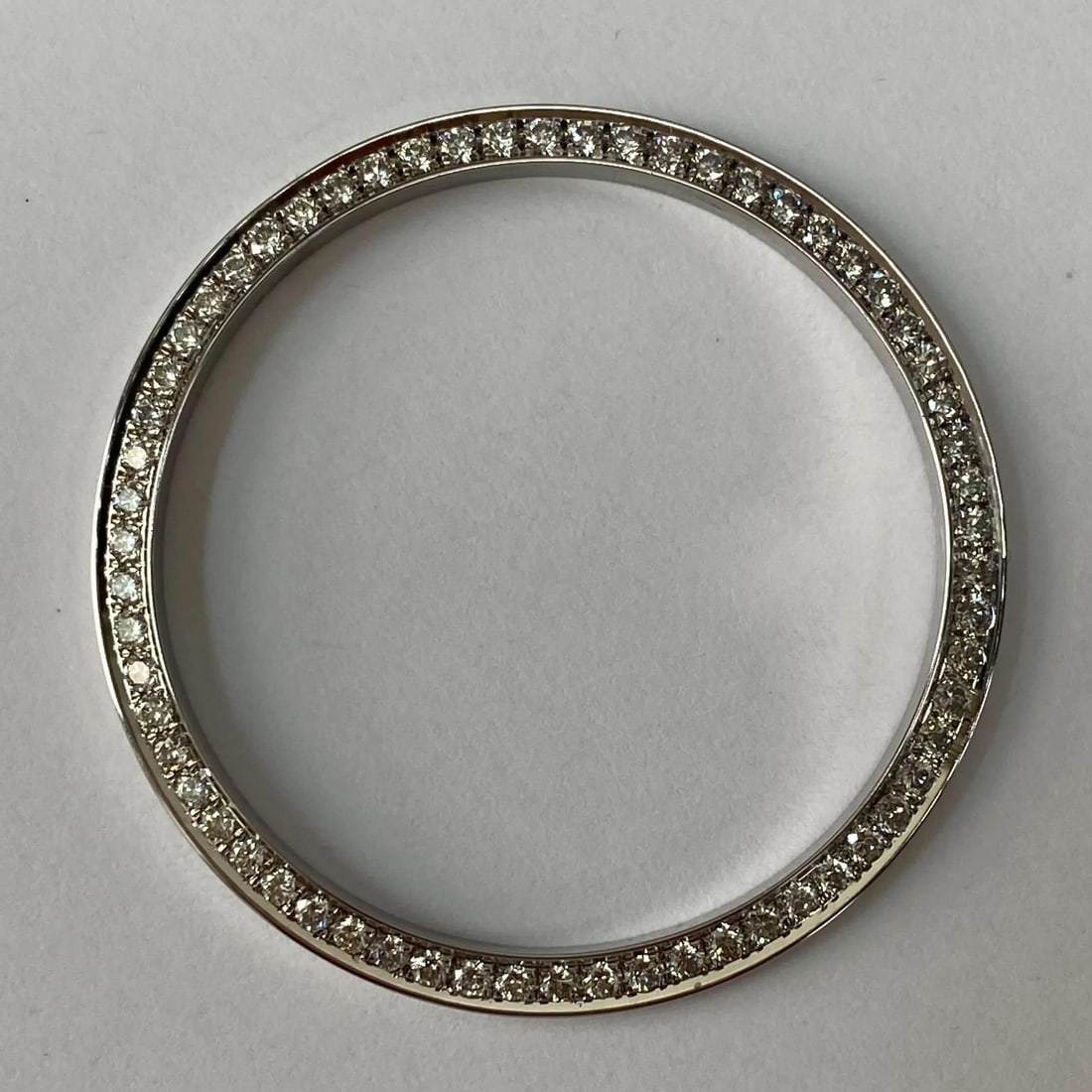 Custom Diamond Bezel 1.25ct for Rolex Oyster Perpetual 41mm: Custom Diamond Bezel 1.25ct for Rolex Oyster Perpetual 41mm Enhance your Rolex Oyster Perpetual 41mm with this exquisite custom steel diamond bezel, featuring a total diamond weight of 1.25 ct. This l