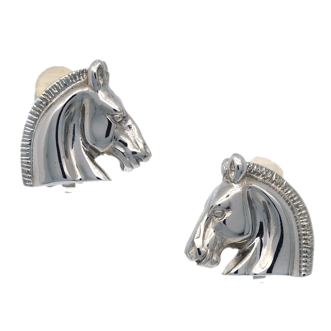 Hermes silver clip-on horse head button earrings: Hermes silver clip-on horse head button earrings These Hermes Bijouterie Fantaisie earrings feature a horse head motif in a silver-tone finish. Designed in a classic button style, they are equipped wi