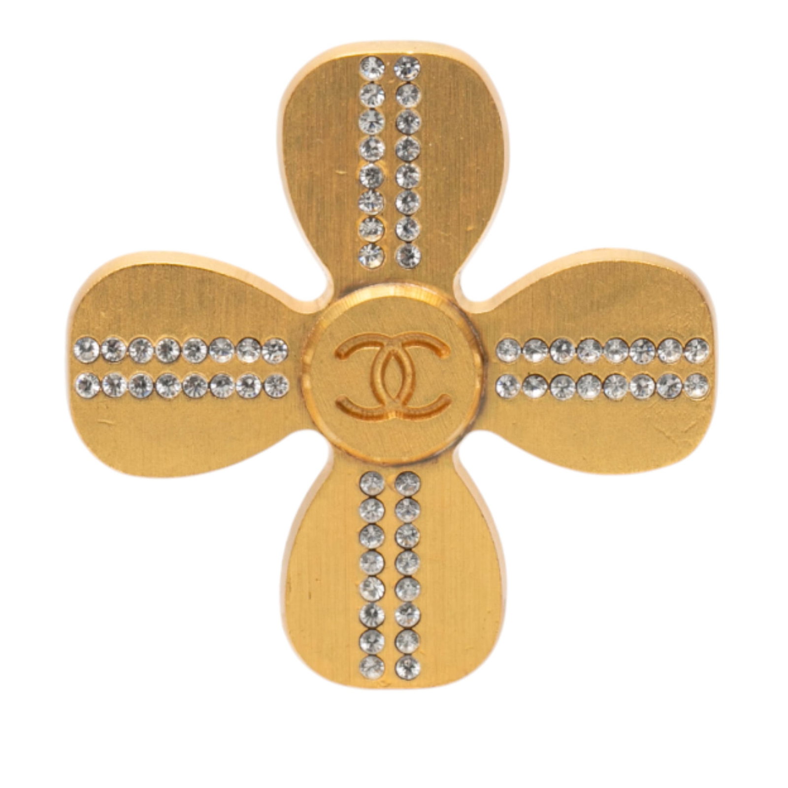 Chanel Clover Brooch Gold Plated Metal with Rhinestone Embellishments: Chanel Clover Brooch Gold Plated Metal with Rhinestone Embellishments This Chanel brooch features a gold-plated metal body adorned with sparkling rhinestone details in a clover shape. It is equipped w