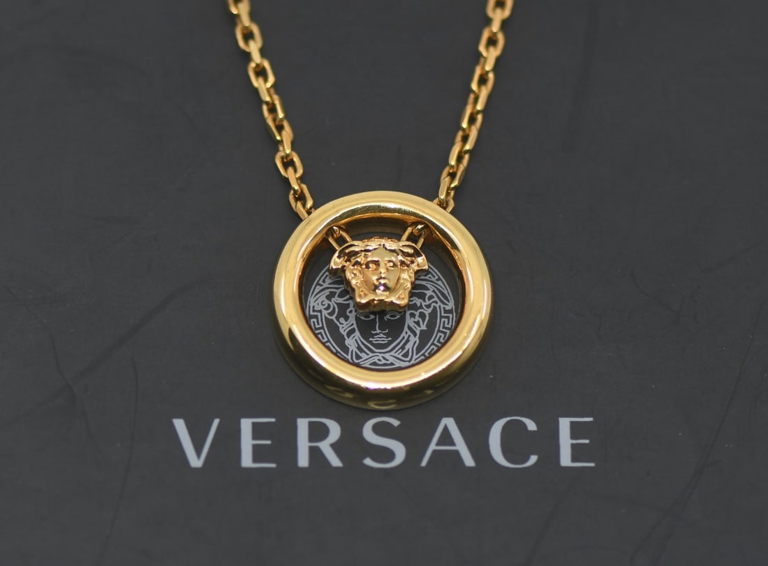 Pendant Necklace by Versace Gold Plated 22 Inch Length: Pendant Necklace by Versace Gold Plated 22 Inch Length This Versace necklace features a gold-plated finish and a pendant style, offering a bold and stylish accessory. The necklace measures 22 inches i