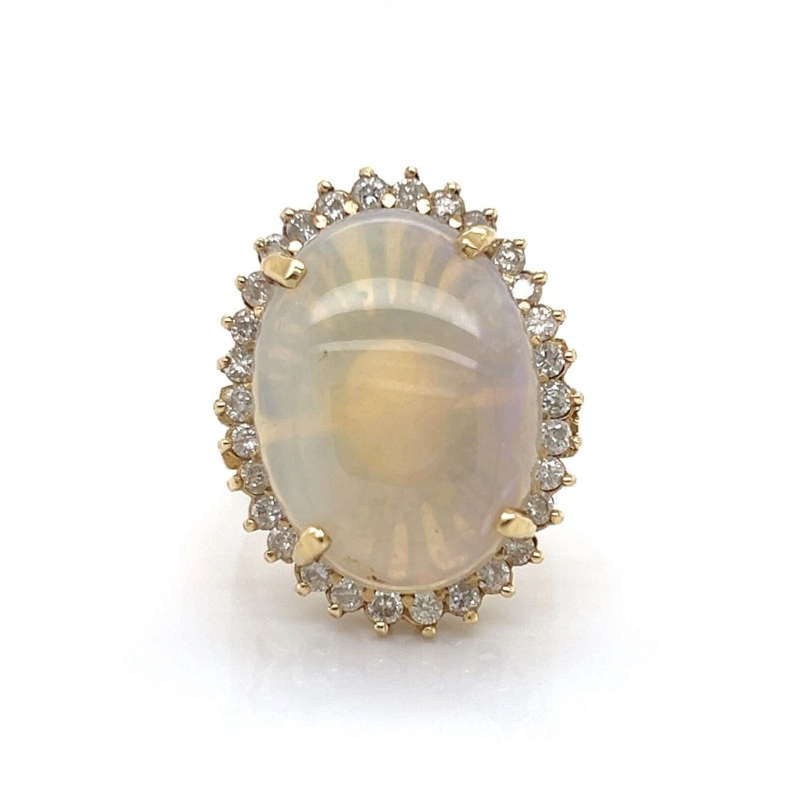 Vintage 14k Yellow Gold Opal Diamond Statement Ring Size 7: Vintage 14k Yellow Gold Opal Diamond Statement Ring Size 7 This vintage statement ring features a striking oval opal set in 14k yellow gold, accented by approximately 0.35 carats of sparkling diamonds