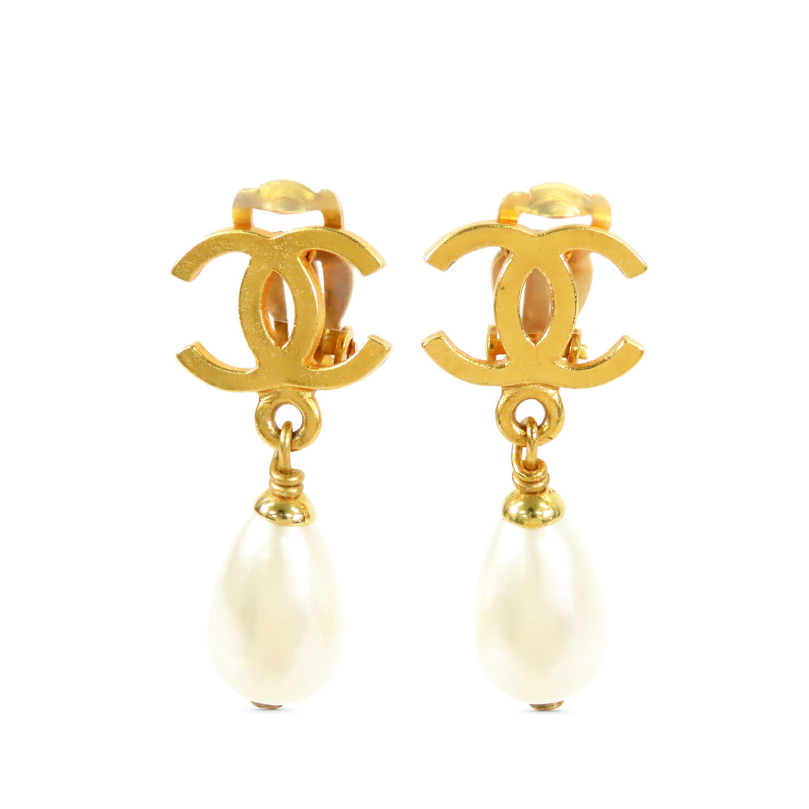 Chanel faux pearl gold plated dangle clip on earrings: Chanel faux pearl gold plated dangle clip on earrings These Chanel CC dangle earrings feature gold-plated metal bodies with faux pearl accents and secure clip-on closures. Made in France, they are cat
