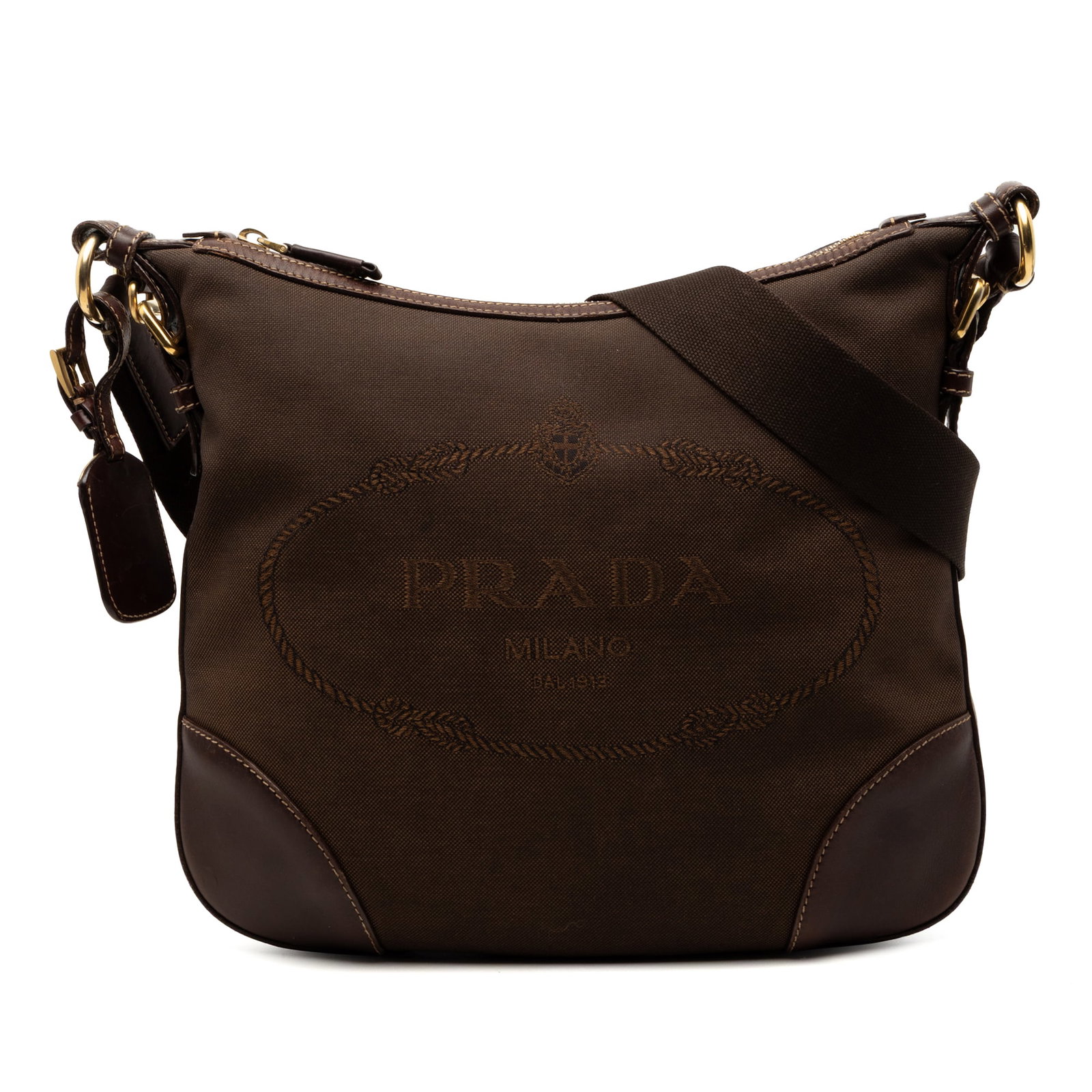 Prada Canapa Canvas Crossbody Bag with Logo and Leather Trim: Prada Canapa Canvas Crossbody Bag with Logo and Leather Trim This Prada Canvas Canapa Logo Crossbody bag features a brown canvas body with leather trim, an adjustable flat strap, a top zip closure, an
