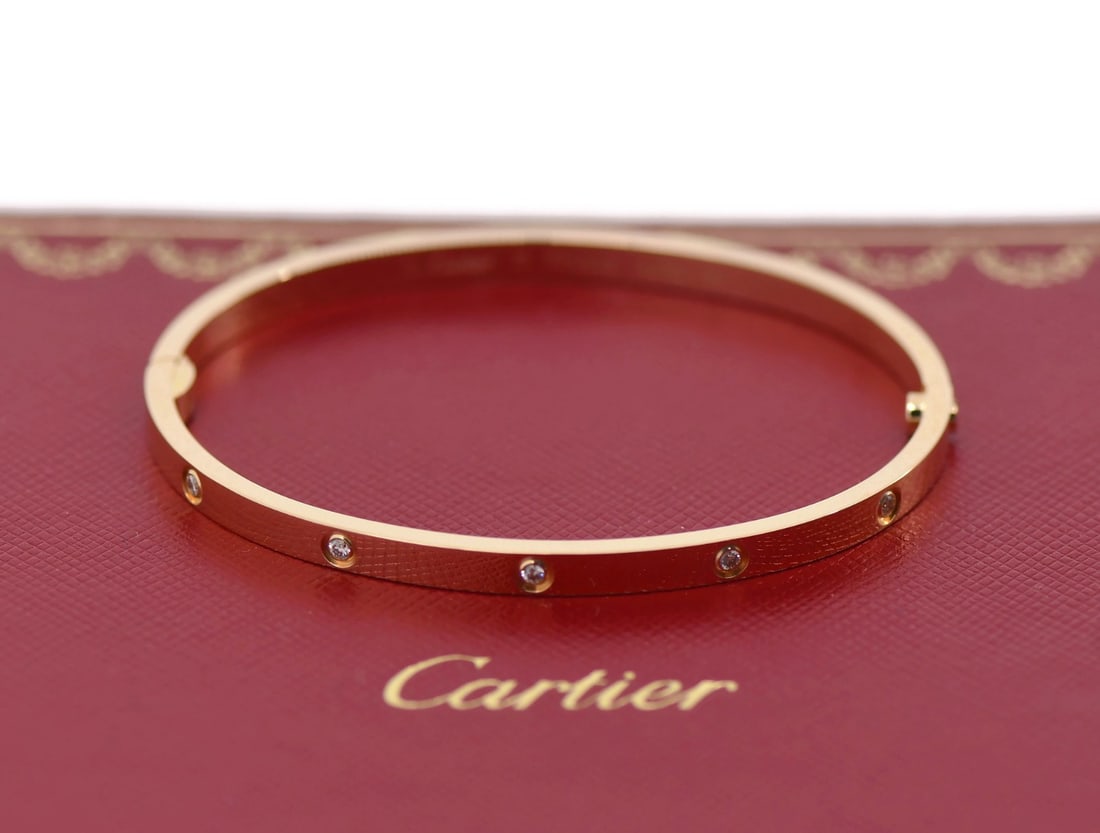 Cartier Love Bracelet 10 Diamonds 18K Rose Gold Size 17 Authentic: Cartier Love Bracelet 10 Diamonds 18K Rose Gold Size 17 Authentic Presenting the exquisite Cartier Love Bracelet, a stunning piece crafted in 18K rose gold. This small model bracelet features 10 spark