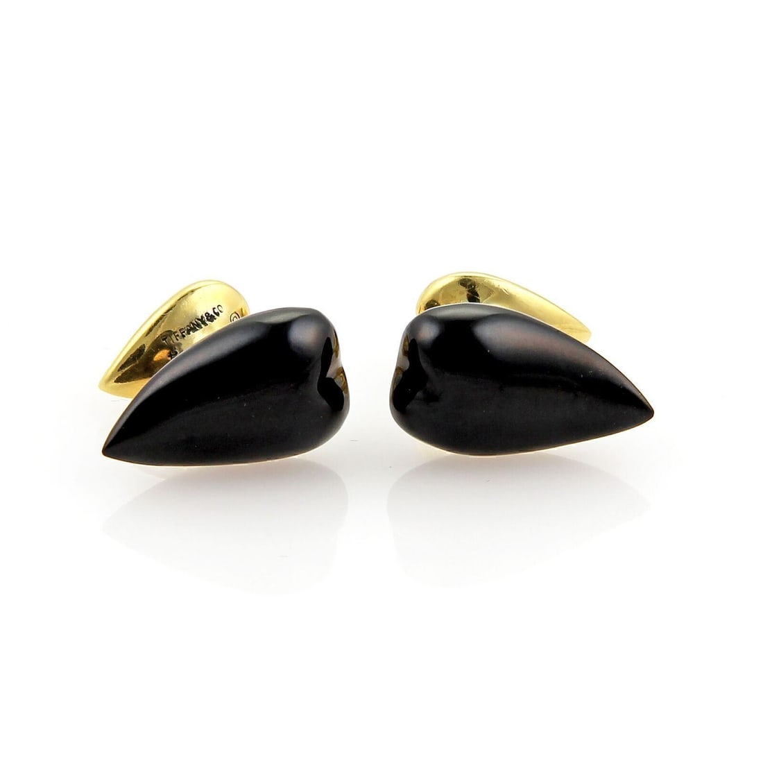 Elsa Peretti onyx cufflinks Tiffany & Co. 18k yellow gold: Elsa Peretti onyx cufflinks Tiffany & Co. 18k yellow gold These Tiffany & Co. cufflinks, designed by Elsa Peretti, are crafted from 18k yellow gold and feature striking black onyx studs. The pair show