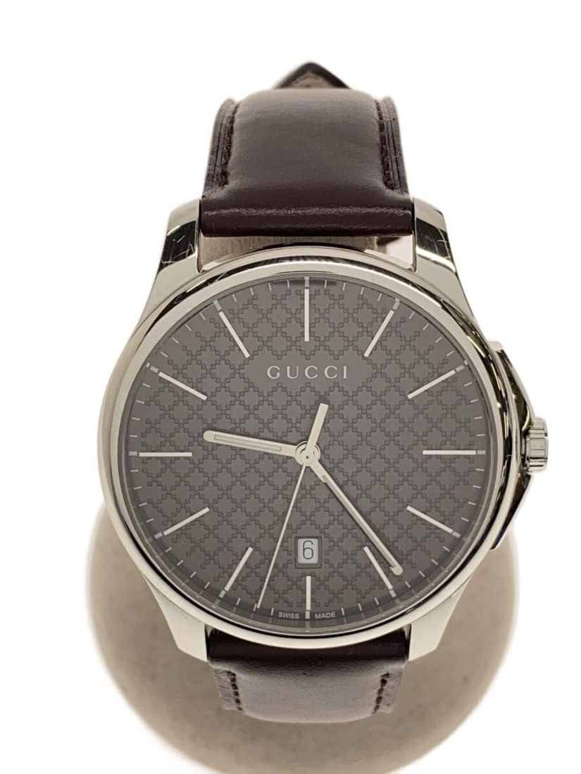 Gucci G Timeless Brown Leather Quartz Men's Wristwatch Box: Gucci G Timeless Brown Leather Quartz Men's Wristwatch Box This is a pre-owned men's GUCCI G-Timeless Quartz 126.3 wristwatch featuring a brown leather band. The watch is Swiss-made and shows slight s